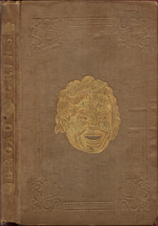Cover Brown cloth cover with gold-stamped smiling face in the center. The spine has the name of the book on it, also in gold.