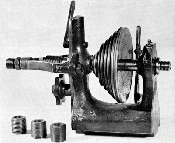 Figure 16. Figure 16.—Headstock of a German instrument-maker’s lathe, typical of the mid-19th century, showing the traverse spindle, interchangeable lead screws, and semicircumferential nut containing several leads. The nut may be brought into engagement by the lever at top rear of the headstock. This releases the end thrust control on the spindle simultaneously with engagement of the nut. (Smithsonian photo 49839.)