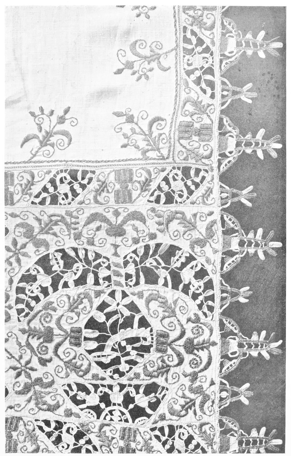 Corner of table cloth with cutouts and     embroidery Corner of table cloth with cutouts and     embroidery